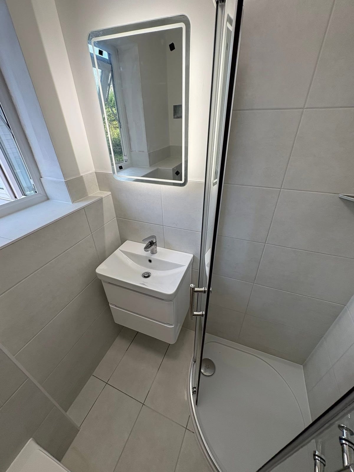 New walk-in shower enclosure and tiling detail